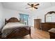 Bedroom with ceiling fan, light hardwood floors, window and dresser set at 10456 N State Rd 267, Brownsburg, IN 46112