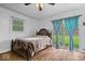 Bedroom with dark wood furniture, window, sliding glass door and hardwood floors at 10456 N State Rd 267, Brownsburg, IN 46112