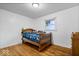 Bedroom with hardwood floors, a wooden toddler bed and a window at 10456 N State Rd 267, Brownsburg, IN 46112