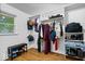 Organized closet with built-in shelving, clothing racks and bench; hardwood floors at 10456 N State Rd 267, Brownsburg, IN 46112