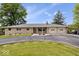 Well-maintained stone ranch home with a circular drive, mature trees, and two-car garage at 10456 N State Rd 267, Brownsburg, IN 46112