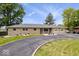 Charming ranch home boasts a circular drive, mature trees, and a two-car garage at 10456 N State Rd 267, Brownsburg, IN 46112