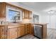 Bright kitchen featuring stainless steel appliances, wood cabinets, and durable gray flooring at 10456 N State Rd 267, Brownsburg, IN 46112