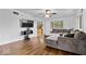 Inviting living room with wood floors, a large sectional sofa, and modern entertainment setup at 10456 N State Rd 267, Brownsburg, IN 46112