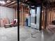 Unfinished basement featuring water tank and other utility fixtures and exposed wooden beams at 12253 Bedrock Ct, Fishers, IN 46037