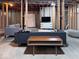 Spacious unfinished basement with exposed ceiling, modern sofas and tv setup at 12253 Bedrock Ct, Fishers, IN 46037