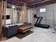 Unfinished basement featuring exposed ceiling, modern sofas, and a treadmill at 12253 Bedrock Ct, Fishers, IN 46037