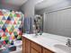 Bathroom featuring double vanity, toilet and shower with colorful curtain at 12253 Bedrock Ct, Fishers, IN 46037