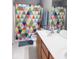 Bathroom featuring double vanity, toilet and shower with colorful curtain at 12253 Bedrock Ct, Fishers, IN 46037