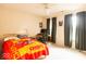 Bedroom features a bed with red and yellow comforter and desk with computer at 12253 Bedrock Ct, Fishers, IN 46037