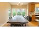 Dining area with large windows and a long wooden table for Gathering gatherings at 12253 Bedrock Ct, Fishers, IN 46037