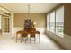 Formal dining room with modern chandelier, wainscoting, and lots of natural light from large windows at 12253 Bedrock Ct, Fishers, IN 46037
