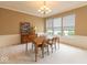 Formal dining area boasts a large window, neutral paint, wainscoting, and modern lighting at 12253 Bedrock Ct, Fishers, IN 46037