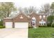 Charming two-story brick home with attached three-car garage and well-manicured front lawn at 12253 Bedrock Ct, Fishers, IN 46037