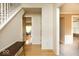 Entry hallway featuring hardwood floors, wainscoting, and staircase with bright, neutral walls at 12253 Bedrock Ct, Fishers, IN 46037