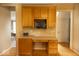 Kitchen desk area with wooden cabinets and white countertop, providing a functional workspace at 12253 Bedrock Ct, Fishers, IN 46037