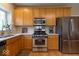 Modern kitchen with stainless steel appliances, white countertops, and oak cabinetry at 12253 Bedrock Ct, Fishers, IN 46037