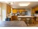 Well-lit kitchen featuring wood cabinets and stainless steel appliances, open to dining area at 12253 Bedrock Ct, Fishers, IN 46037