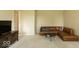 Spacious living room featuring a leather sectional sofa, round coffee table, and neutral carpeting at 12253 Bedrock Ct, Fishers, IN 46037