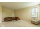 Living room showcasing a cozy leather sectional sofa, armchair, and neutral carpeting at 12253 Bedrock Ct, Fishers, IN 46037