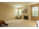 Cozy living room with a fireplace, neutral tones, and plush carpeting at 12253 Bedrock Ct, Fishers, IN 46037
