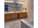 Bright bathroom with dual sinks, a large mirror, and a soaking tub with stylish fixtures at 12253 Bedrock Ct, Fishers, IN 46037
