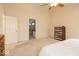 Primary bedroom featuring a view to ensuite bathroom, ceiling fan, and neutral walls at 12253 Bedrock Ct, Fishers, IN 46037