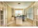 Bright office with built-in cabinets, desk, and large windows offering natural light at 12253 Bedrock Ct, Fishers, IN 46037