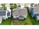 Aerial view of a home with a backyard deck and lush lawn surrounded by neighboring houses and greenery at 12722 Moonseed Dr, Carmel, IN 46032