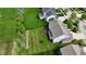 Aerial shot of a landscaped backyard, with a wooden deck, surrounding green grass, and mature trees at 12722 Moonseed Dr, Carmel, IN 46032