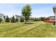 Expansive backyard with lush lawn, mature trees, and serene landscaping, ideal for recreation at 12722 Moonseed Dr, Carmel, IN 46032