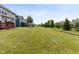 Lush backyard features expansive grassy area, mature trees, and manicured landscaping at 12722 Moonseed Dr, Carmel, IN 46032