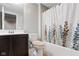 Cozy bathroom features a vanity with sink and shower with decorative shower curtain at 12722 Moonseed Dr, Carmel, IN 46032