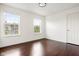 Bright bedroom with two windows, hardwood floors, and ample natural light at 12722 Moonseed Dr, Carmel, IN 46032