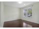 A minimal bedroom featuring wood floors and large window that provides natural light at 12722 Moonseed Dr, Carmel, IN 46032