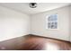 Well lit bedroom with hardwood floors, white walls, and a window with natural light at 12722 Moonseed Dr, Carmel, IN 46032