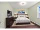 Well-lit bedroom with a mounted TV and a comfortable queen-sized bed at 12722 Moonseed Dr, Carmel, IN 46032