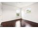 A bright, airy bedroom with gleaming hardwood floors and two windows offering pleasant views at 12722 Moonseed Dr, Carmel, IN 46032