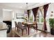 Dining room with natural light, decorative curtains, modern chandelier and wood floors at 12722 Moonseed Dr, Carmel, IN 46032