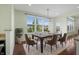Bright dining room featuring a large window and a modern chandelier above a hardwood dining table at 12722 Moonseed Dr, Carmel, IN 46032