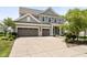 Traditional two-story home featuring a three-car garage and mature landscaping for enhanced curb appeal at 12722 Moonseed Dr, Carmel, IN 46032