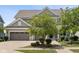 Traditional two-story home featuring a three-car garage and mature landscaping for enhanced curb appeal at 12722 Moonseed Dr, Carmel, IN 46032