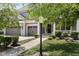 Charming home featuring a three-car garage and inviting front porch with classic architectural details at 12722 Moonseed Dr, Carmel, IN 46032