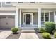 Inviting front porch featuring classic architectural details and a welcoming wreath at 12722 Moonseed Dr, Carmel, IN 46032