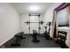 Home gym with rubber flooring, weight rack, and fitness equipment for convenient workouts at 12722 Moonseed Dr, Carmel, IN 46032