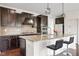 Gourmet kitchen with granite countertops, dark cabinets, and stainless steel appliances at 12722 Moonseed Dr, Carmel, IN 46032