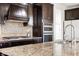 Close up view of gourmet kitchen showcasing granite countertops, gas range, and modern backsplash at 12722 Moonseed Dr, Carmel, IN 46032