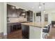 Kitchen with granite countertops, dark wood cabinets, and stainless steel appliances at 12722 Moonseed Dr, Carmel, IN 46032