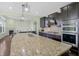 Spacious kitchen with granite counters, stainless steel appliances and dark wood cabinetry at 12722 Moonseed Dr, Carmel, IN 46032
