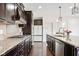 Kitchen featuring granite countertops, dark cabinets, stainless steel appliances and center island at 12722 Moonseed Dr, Carmel, IN 46032